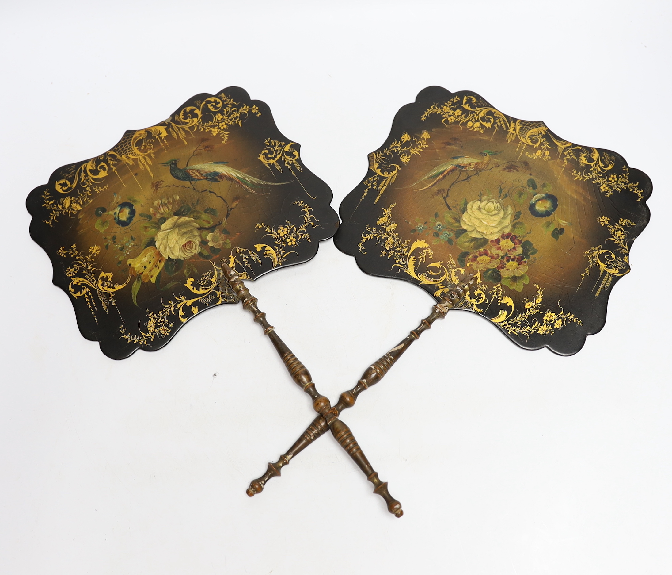 Two Regency papier mache face screens decorated with flowers and peacocks, 39cm high